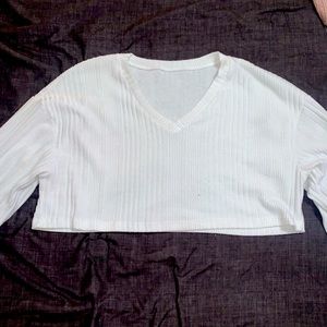 A long sleeve white crop top.